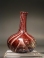 Early Roman red and white glass ribbon flask.