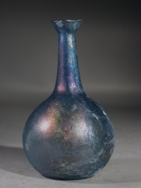 Early Roman blue glass unguentarium (cosmetic flask).
