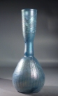Roman light blue glass bottle with ribbed body and trailed neck.